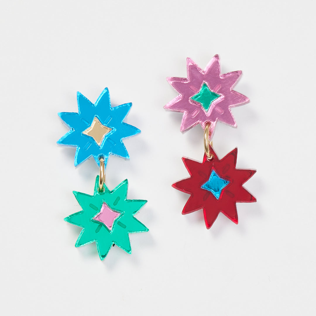 Multi coloured double star earrings on a white background