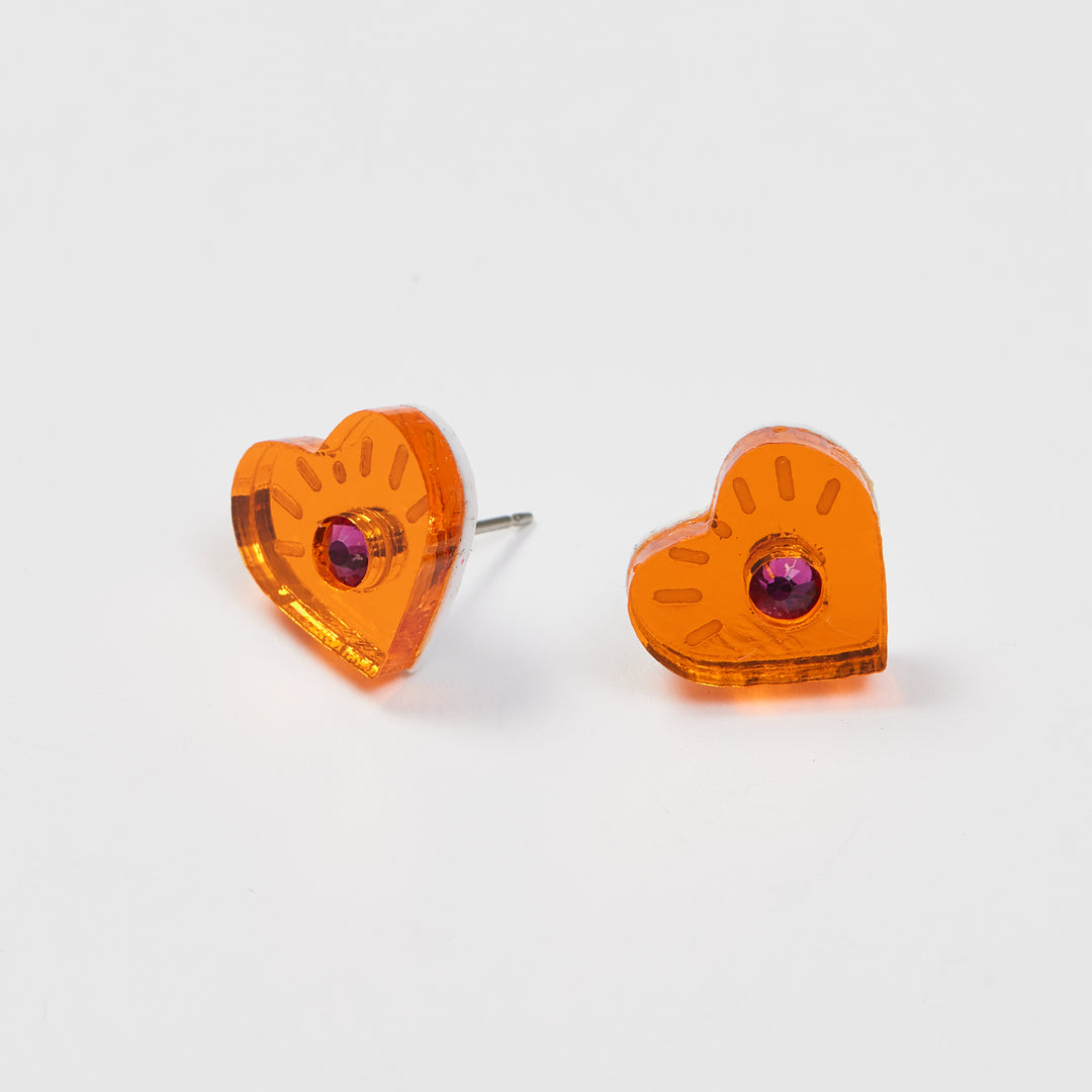Heart studs that look like eyes. Orange acrylic mirror with a crystal