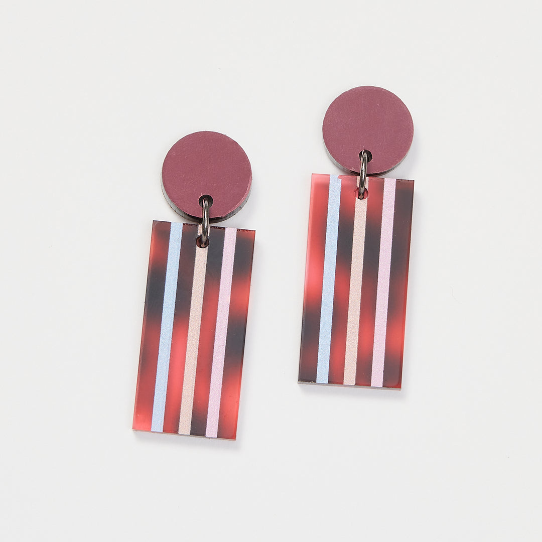 Tortoise Shell earrings with stripes on a white back ground