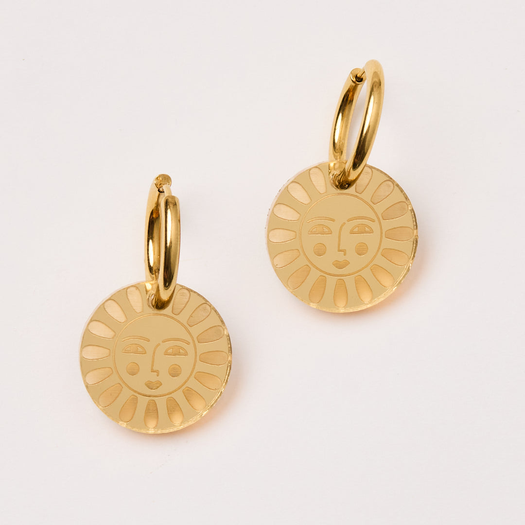 laser cut acrylic flower charm earrings with a face hang in gold mirror
